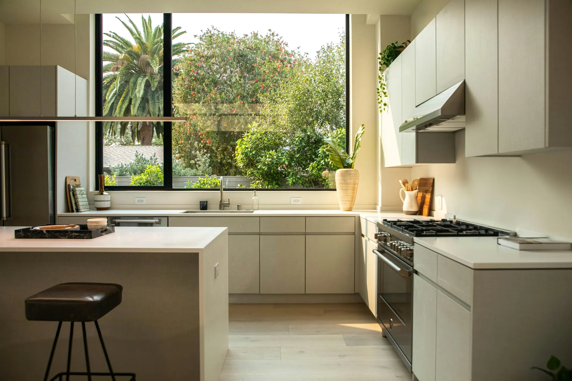 Kitchen with an island, flat-panel cabinets and a large picture window